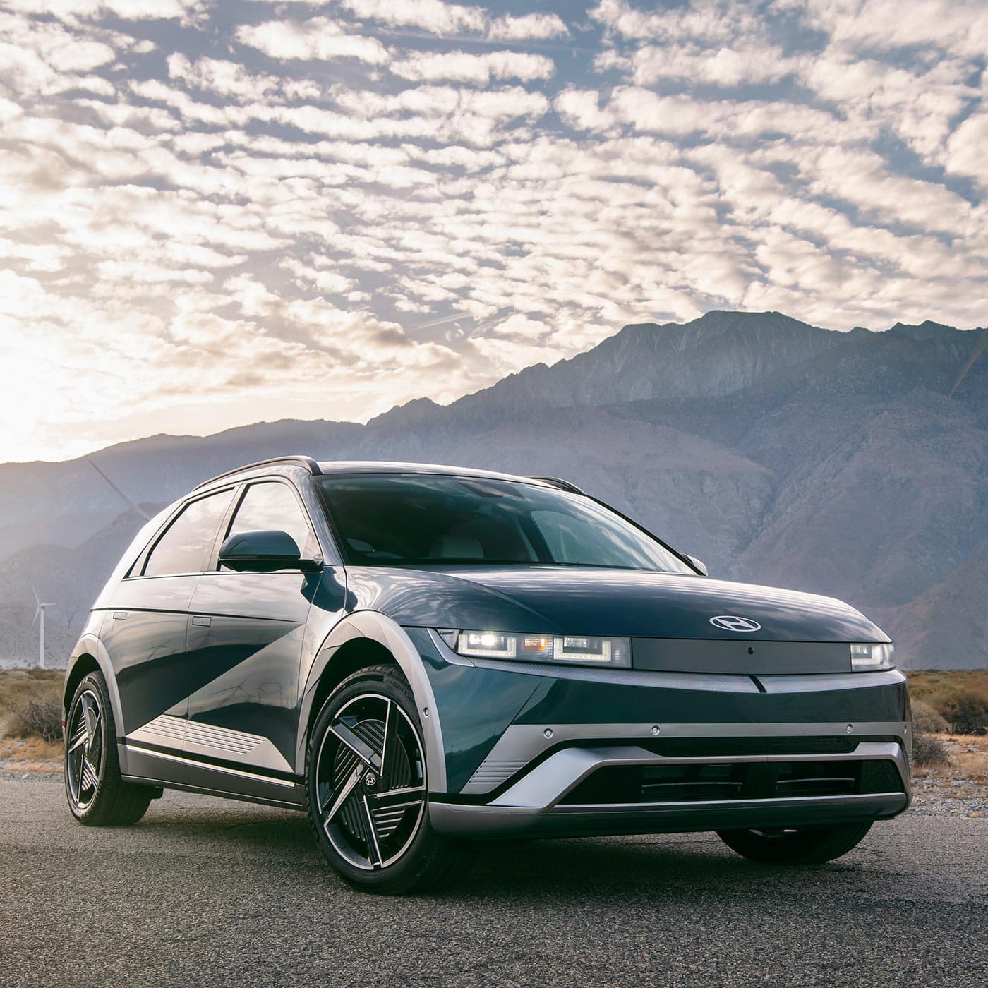 A Hyundai 2026 IONIQ 5 electric vehicle with mountains in the background. A Hyundai 2026 IONIQ 5 electric vehicle with mountains in the background.