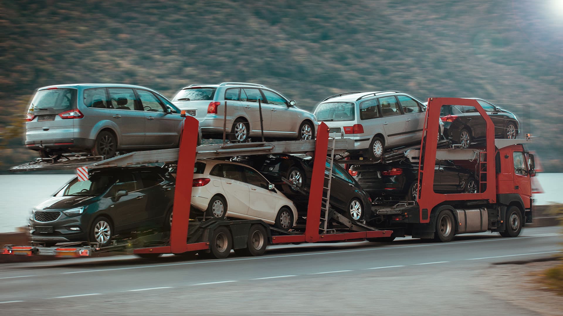 Car carrier truck in motion, transporting fleet vehicles. Car carrier truck in motion, transporting fleet vehicles.